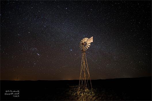 student photo of a windmill and the Milky Way behind it